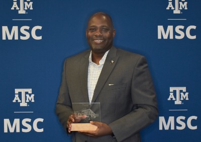 Person Posing for Picture with Award